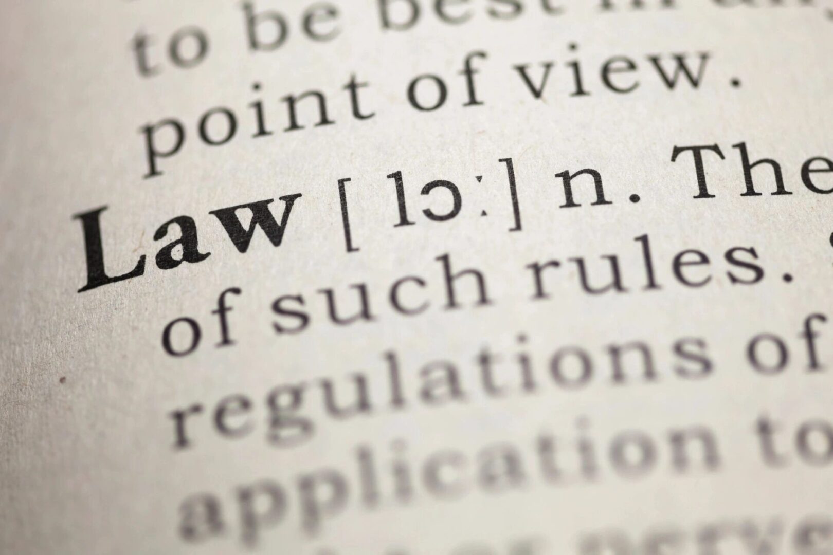 A close up of the word law in a dictionary